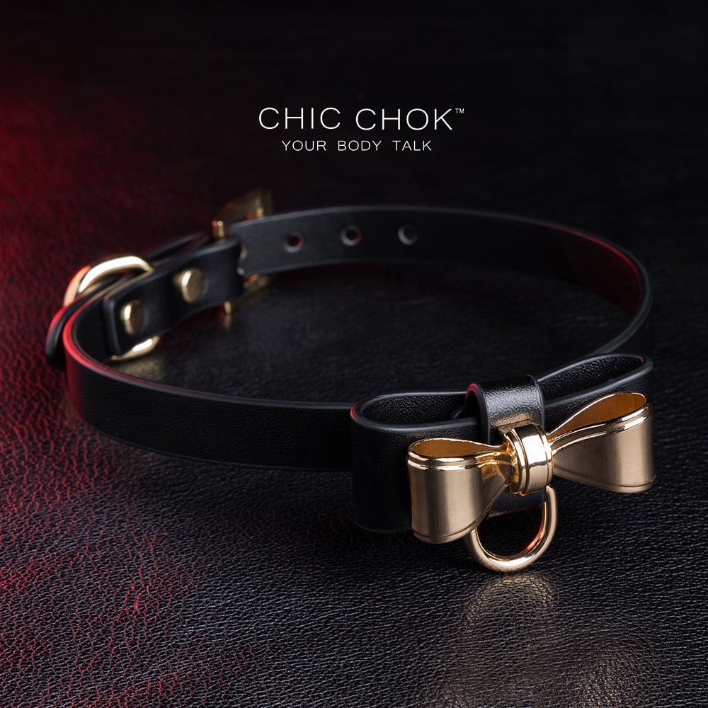 Elegant choker featuring a golden bow design symbolizing nobility, unity, and individuality, set against a vibrant color contrast to represent diverse social statuses, personalities, and backgrounds while celebrating love and mutual respect.