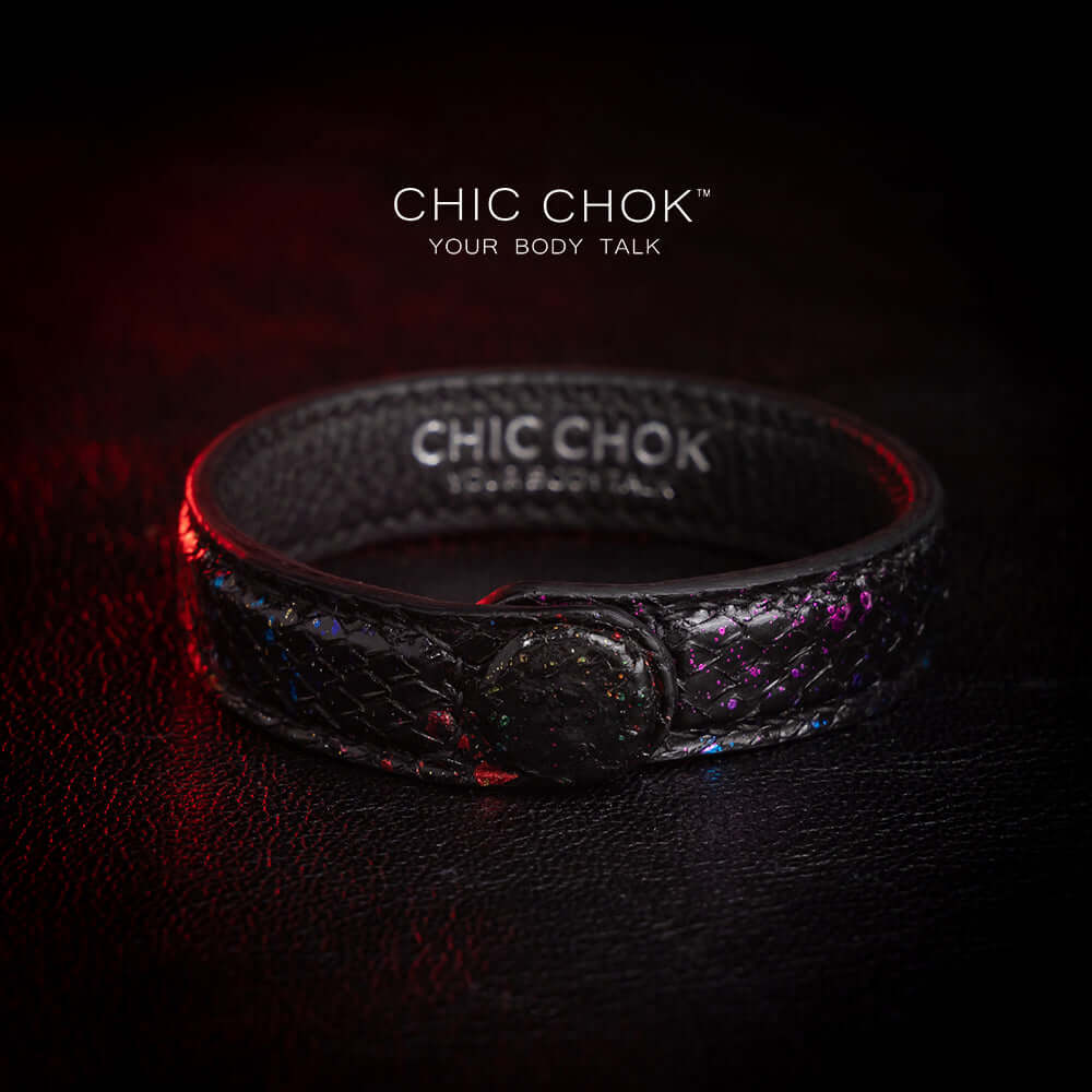 Nebula Doll Bracelet Luxurious black leather bracelet with textured scales, adorned with shimmering multicolor glitter accents, inspired by the brilliance of a starry night sky, showcasing elegance and individuality.
