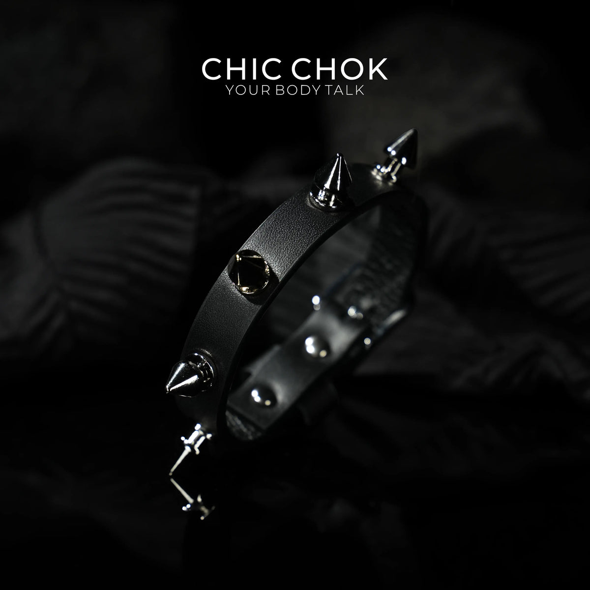 Spiked Fury Bracelet with tall silver-colored cones and lower rounded studs on a black band