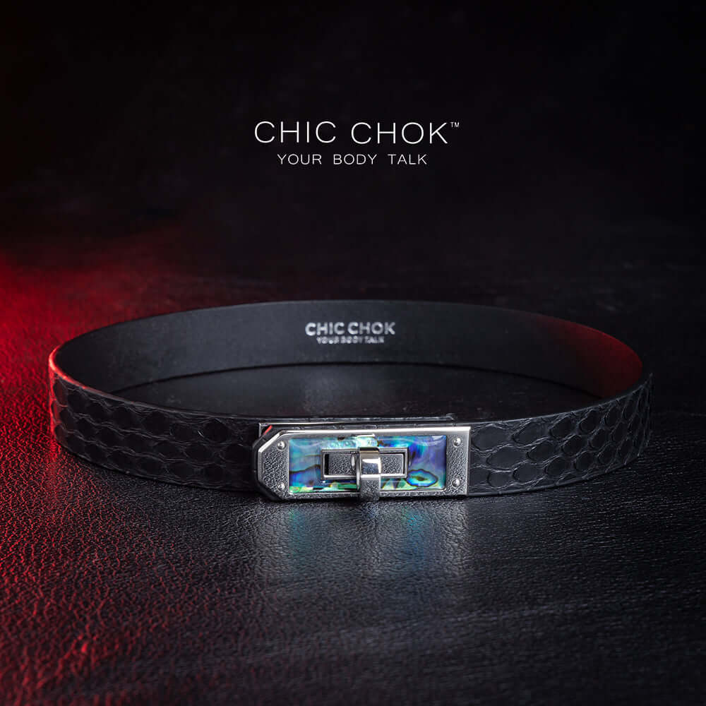 chicchok black python hide collar with green sea shell buckle, featuring a mysterious and mature vibe, luxury textured design for bold fashion statements.