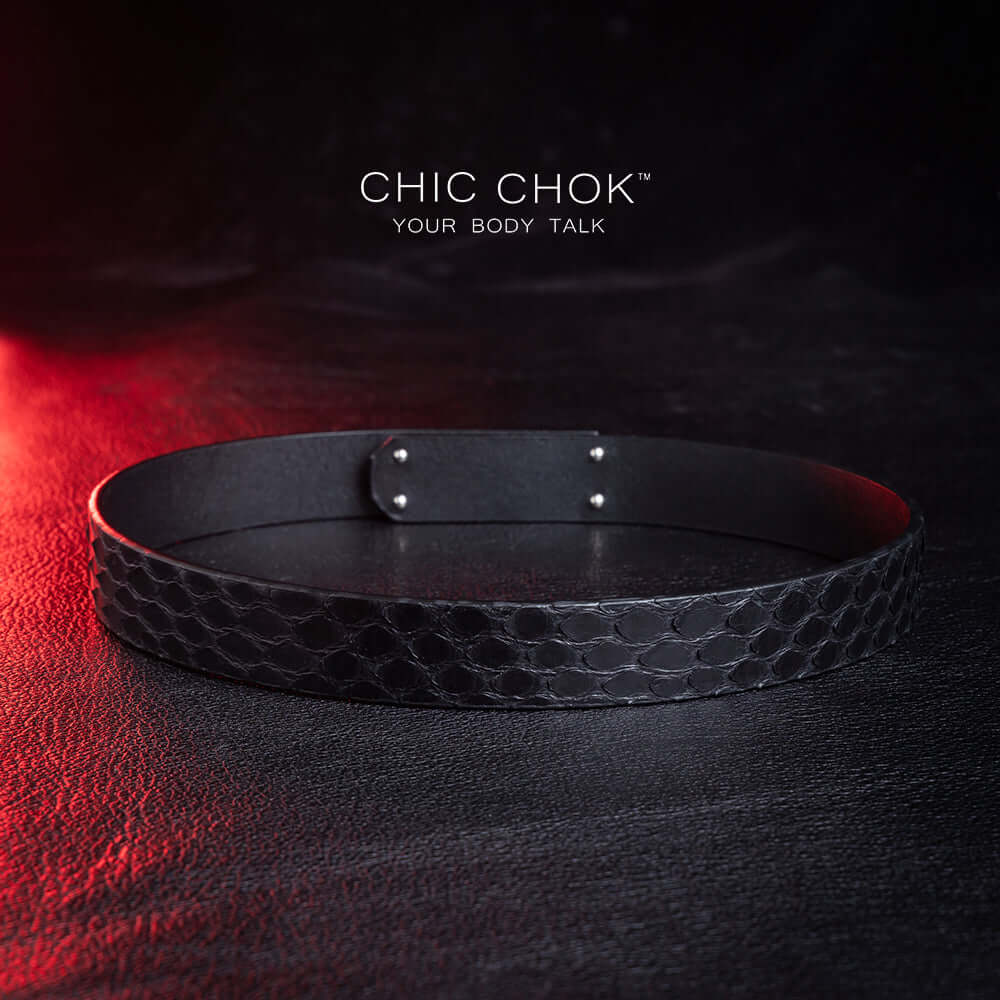 chicchok black python hide collar with green sea shell buckle, featuring a mysterious and mature vibe, luxury textured design for bold fashion statements.