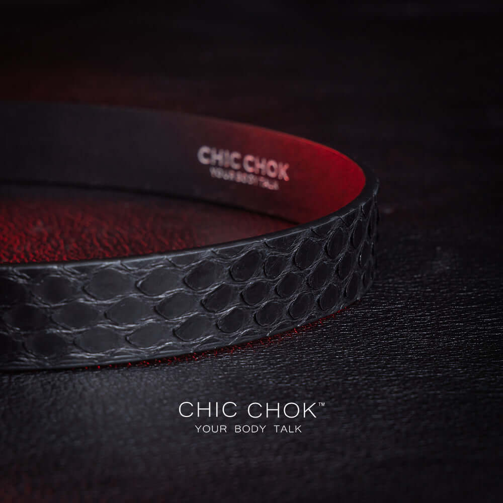 chicchok black python hide collar with green sea shell buckle, featuring a mysterious and mature vibe, luxury textured design for bold fashion statements.