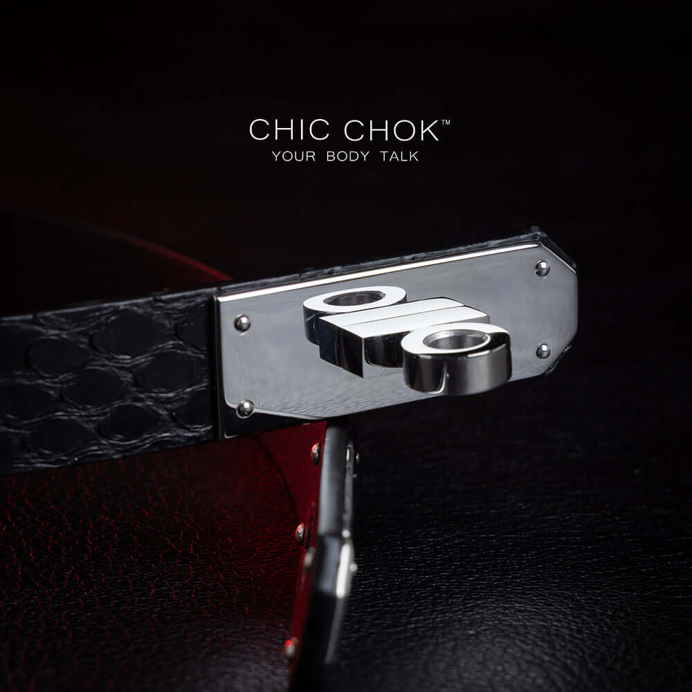 chicchok black python hide collar with green sea shell buckle, featuring a mysterious and mature vibe, luxury textured design for bold fashion statements.