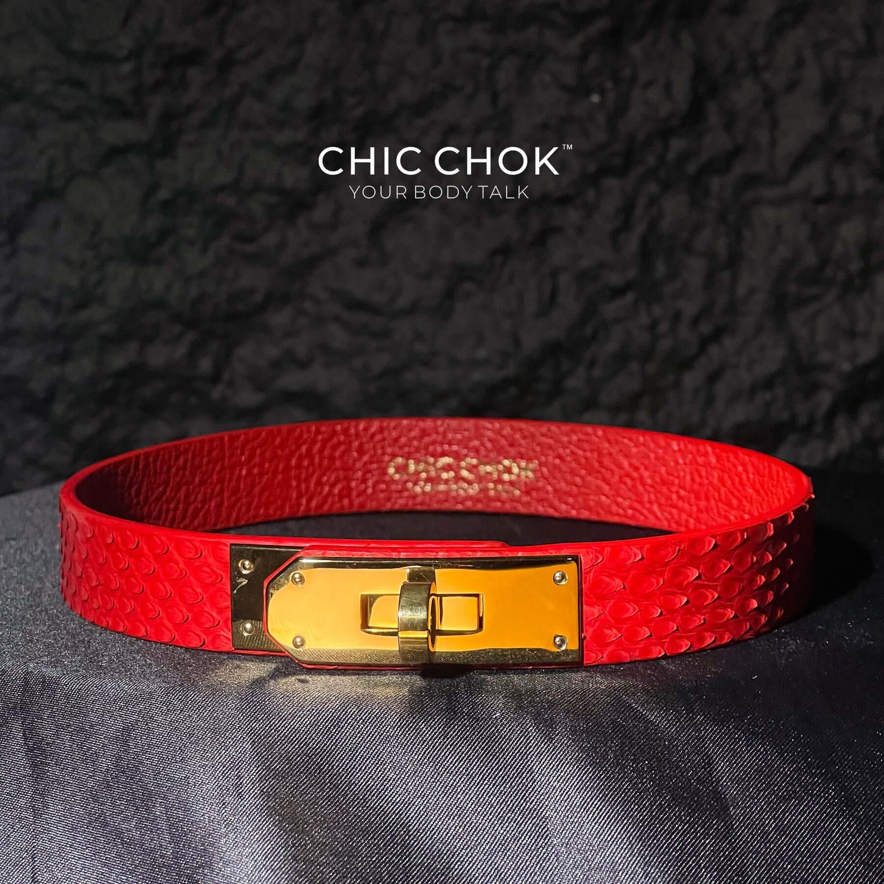 A vibrant red textured leather bracelet featuring a gold-tone stainless steel lock closure, designed by CHICCHOK for bold and luxurious style. Ideal for versatile fashion statements and perfect as a gift.