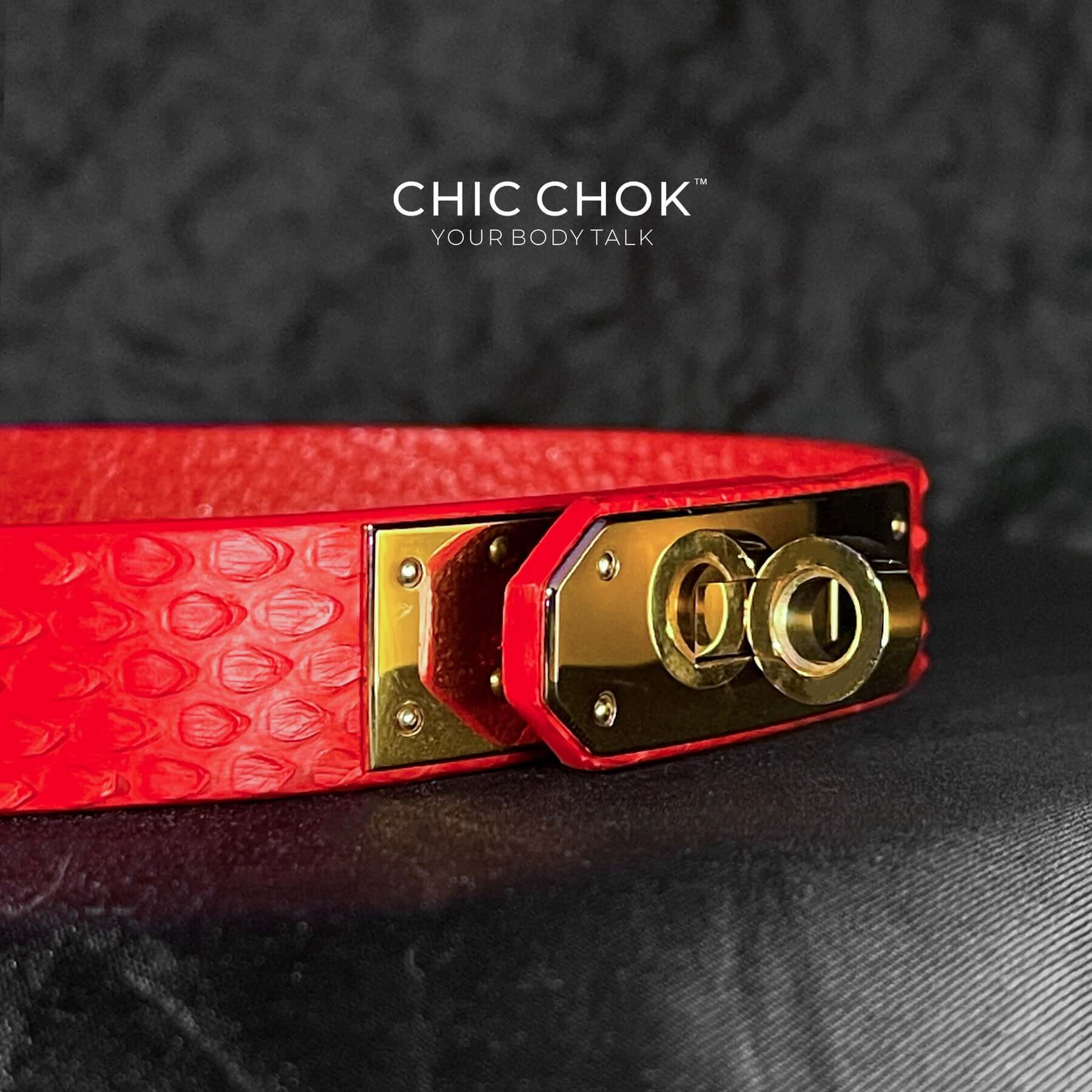 A vibrant red textured leather bracelet featuring a gold-tone stainless steel lock closure, designed by CHICCHOK for bold and luxurious style. Ideal for versatile fashion statements and perfect as a gift.