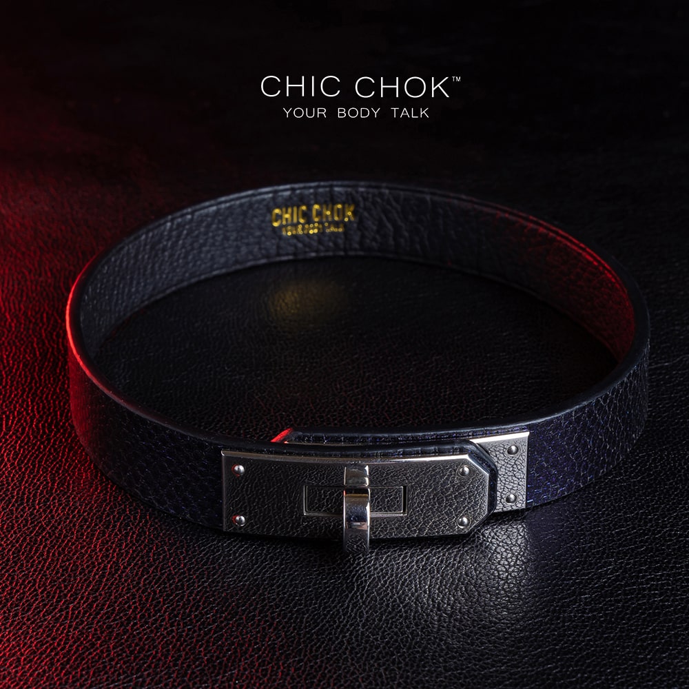 chicchok black textured leather choker with a sleek metallic silver locking mechanism, featuring bold craftsmanship and gold branding, designed for edgy and sophisticated fashion styles.
