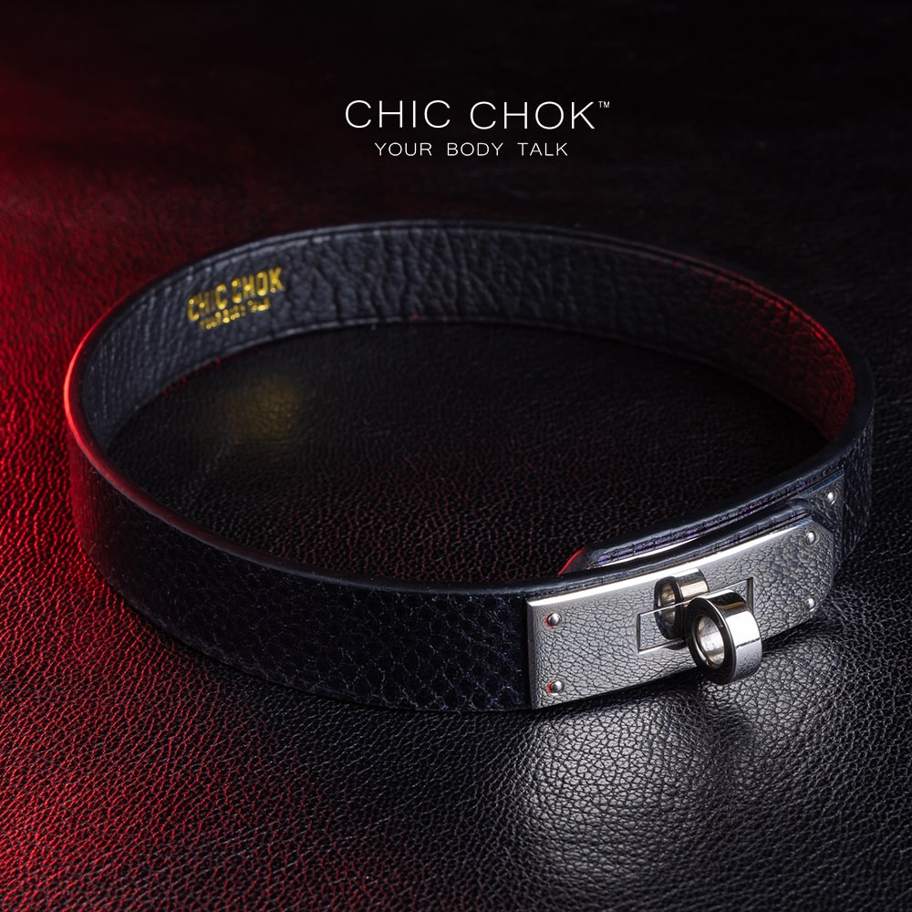 chicchok black textured leather choker with a sleek metallic silver locking mechanism, featuring bold craftsmanship and gold branding, designed for edgy and sophisticated fashion styles.