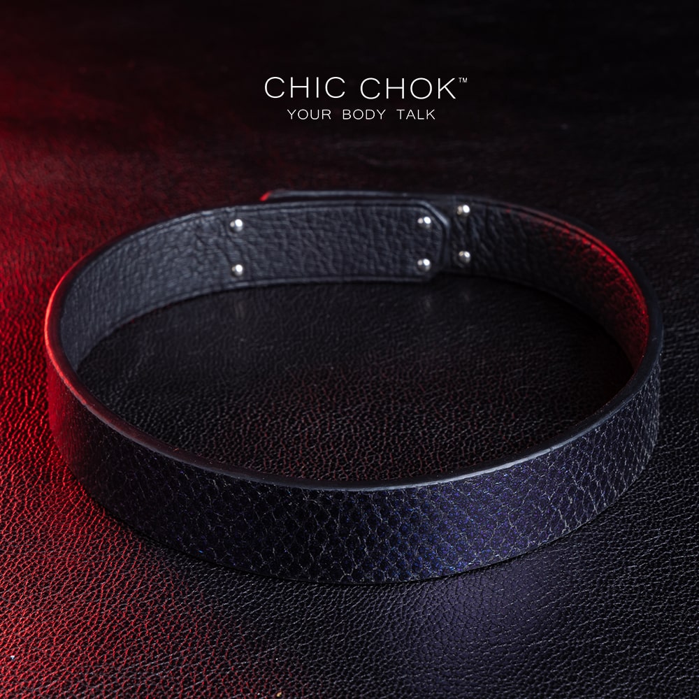 chicchok black textured leather choker with a sleek metallic silver locking mechanism, featuring bold craftsmanship and gold branding, designed for edgy and sophisticated fashion styles.