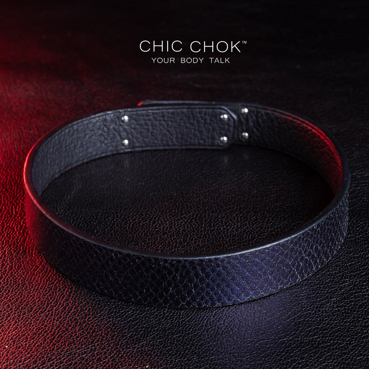 chicchok black textured leather choker with a sleek metallic silver locking mechanism, featuring bold craftsmanship and gold branding, designed for edgy and sophisticated fashion styles.