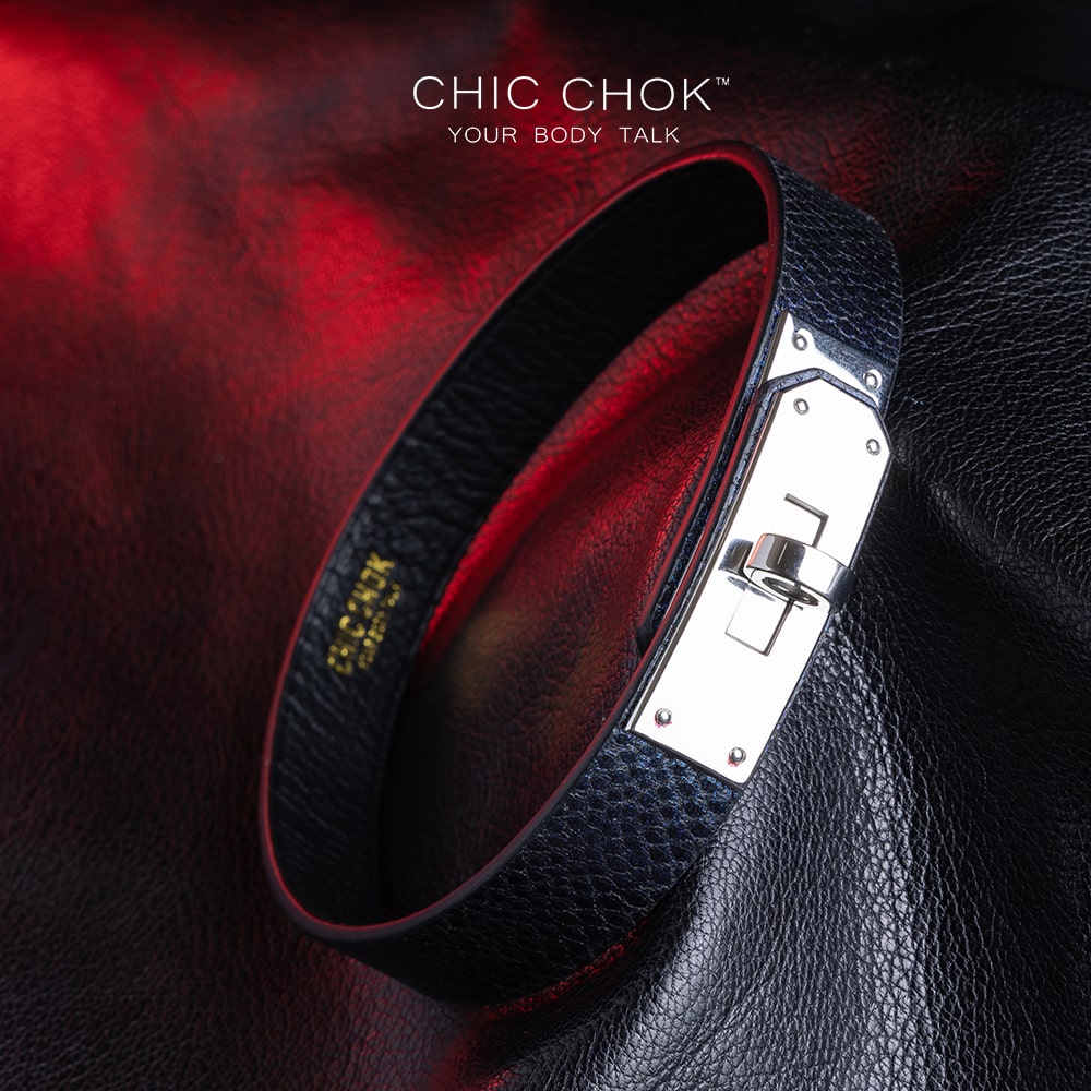 chicchok black textured leather choker with a sleek metallic silver locking mechanism, featuring bold craftsmanship and gold branding, designed for edgy and sophisticated fashion styles.