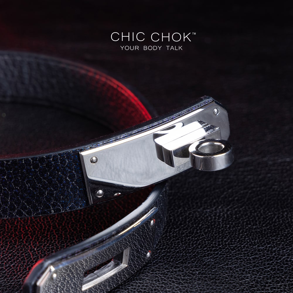 chicchok black textured leather choker with a sleek metallic silver locking mechanism, featuring bold craftsmanship and gold branding, designed for edgy and sophisticated fashion styles.