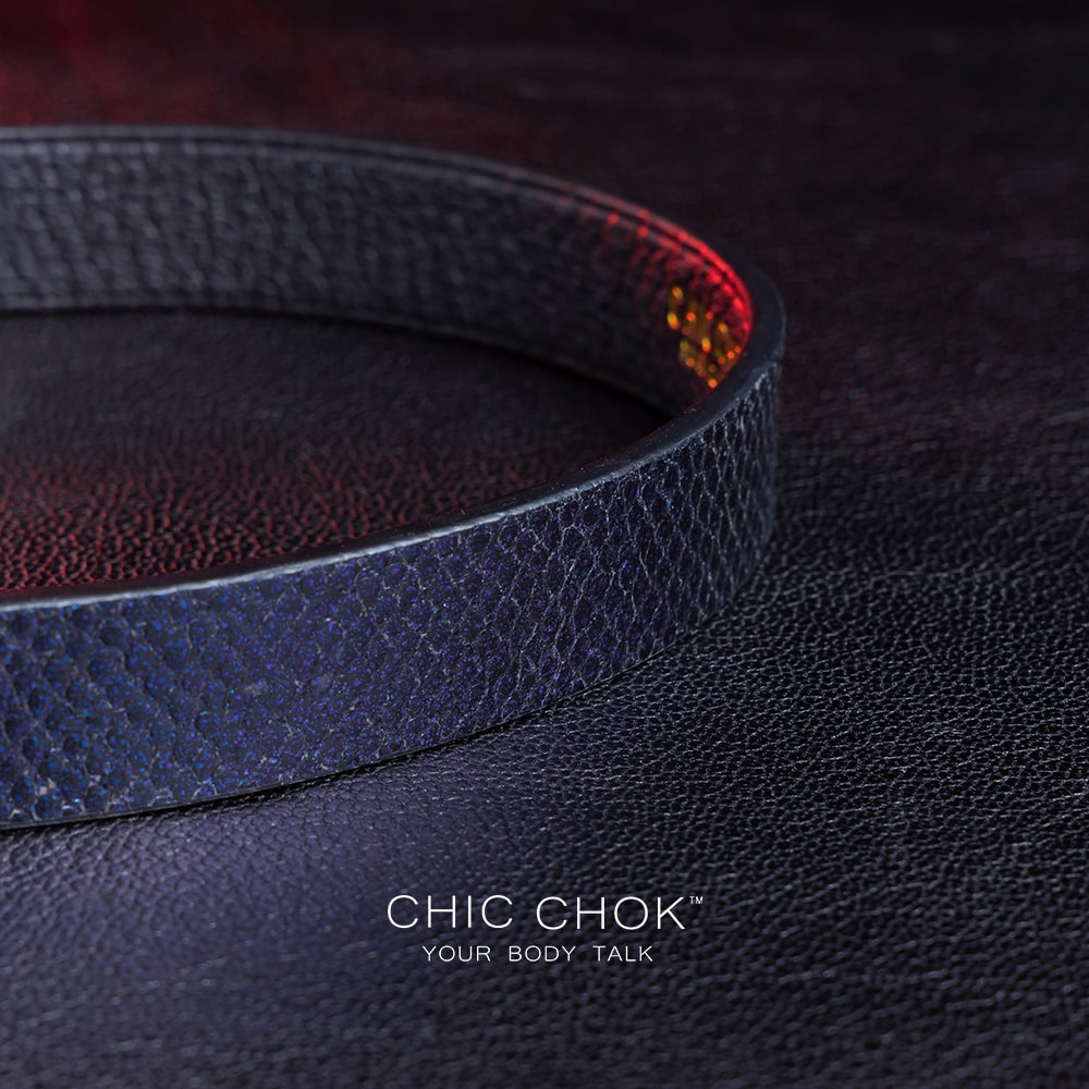 chicchok black textured leather choker with a sleek metallic silver locking mechanism, featuring bold craftsmanship and gold branding, designed for edgy and sophisticated fashion styles.
